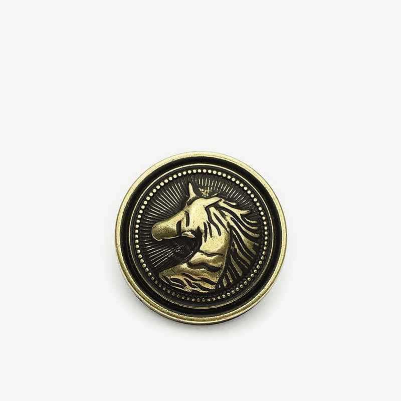 Round horse head metal shank button with gold horse detail on dark background