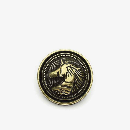 Round horse head metal shank button with gold horse detail on dark background