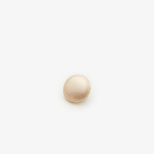 Light pink pearl sew-on button with metal backing for blouses, close-up