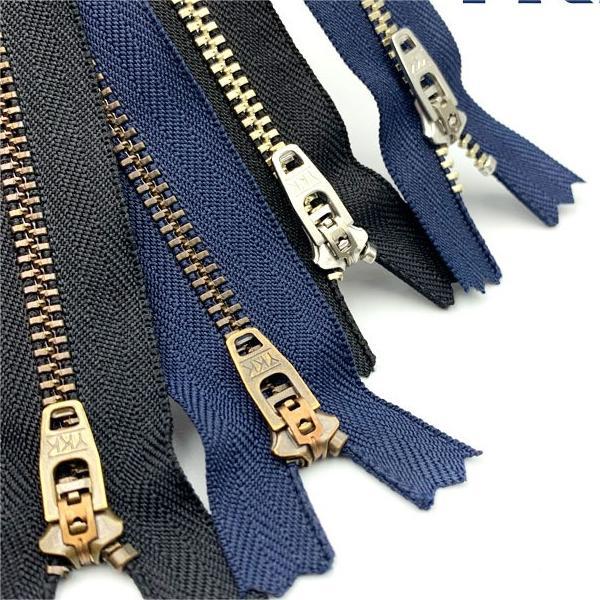 YKK metal closed-end zippers, navy tape, brass sliders and end stops