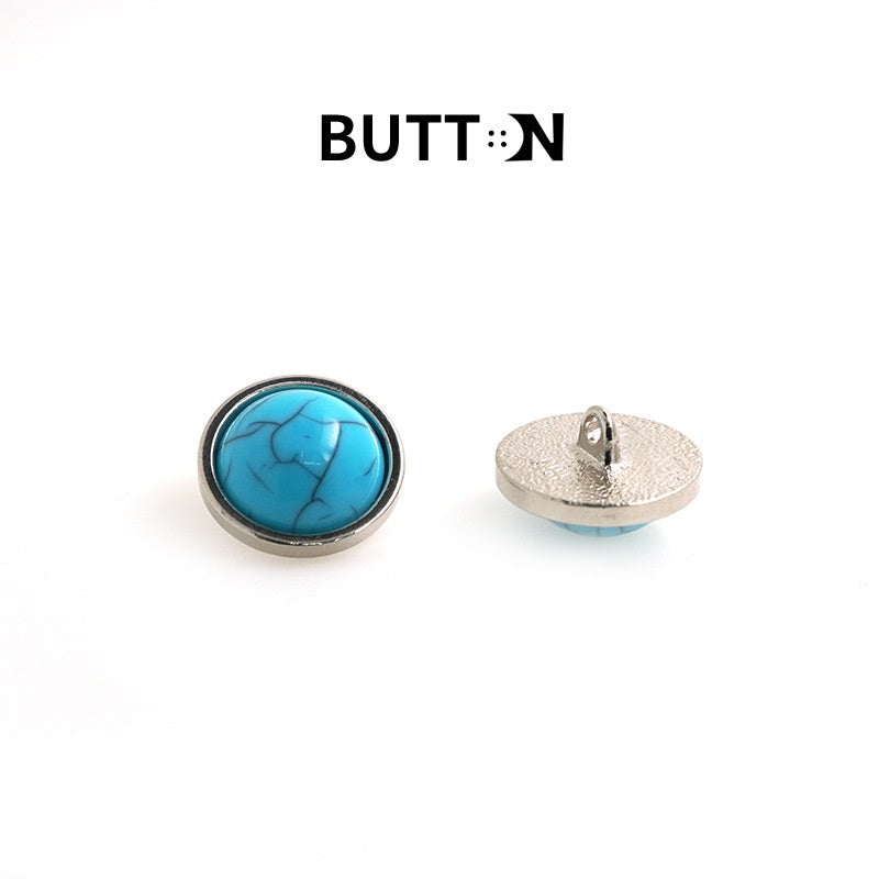 Turquoise crackle metal button with shank and silver back, side view